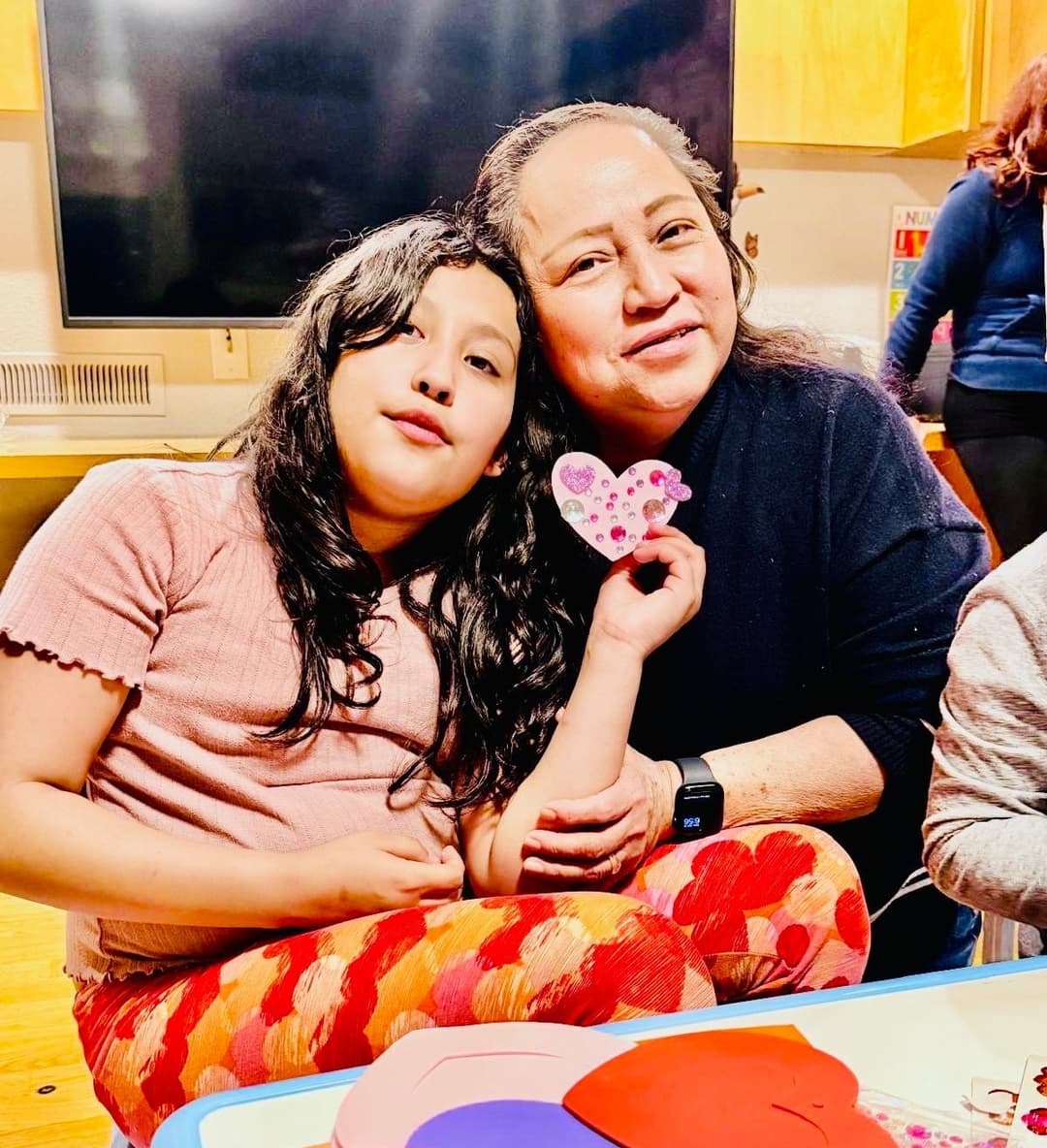 picture of kids in a daycare sitting together learning with an early childhood educator