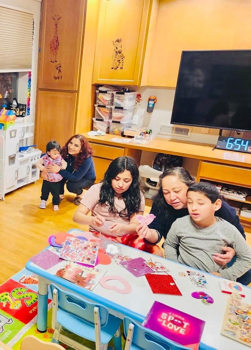 picture of kids in a daycare sitting together learning with an early childhood educator